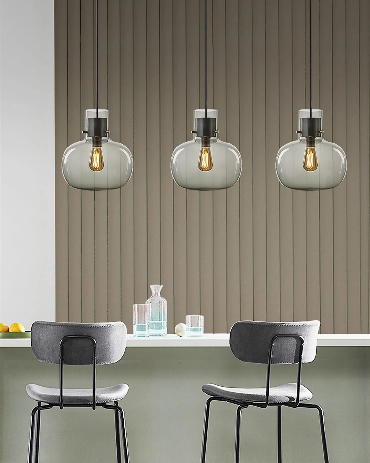 Series of Awa pendant lights with clear glass shades and matte black hardware, modern kitchen counter, Scandinavian minimalist style