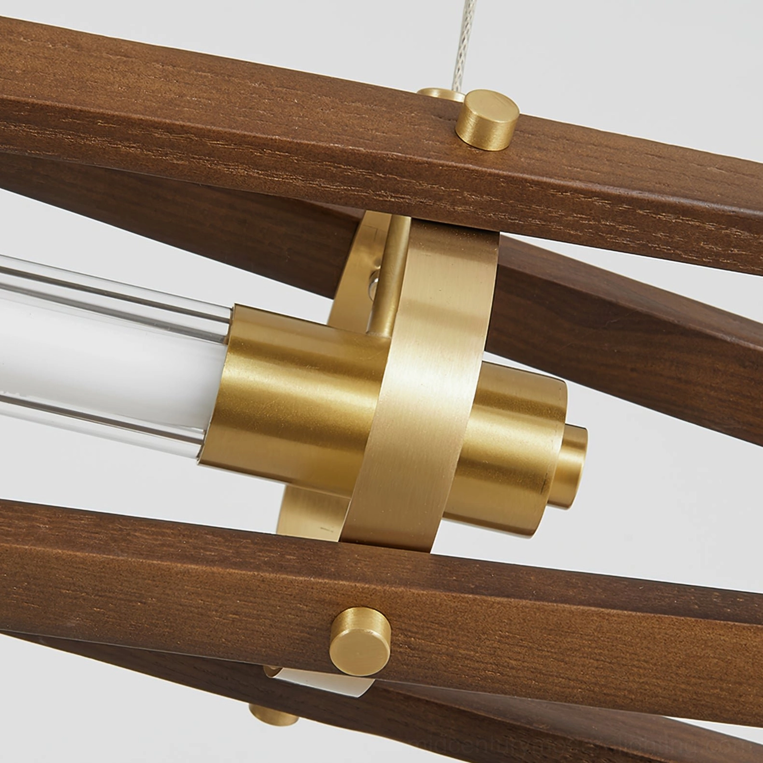 Close-up detail of Axis wood chandelier showing brass joints, walnut wood construction, and transparent lamp tube