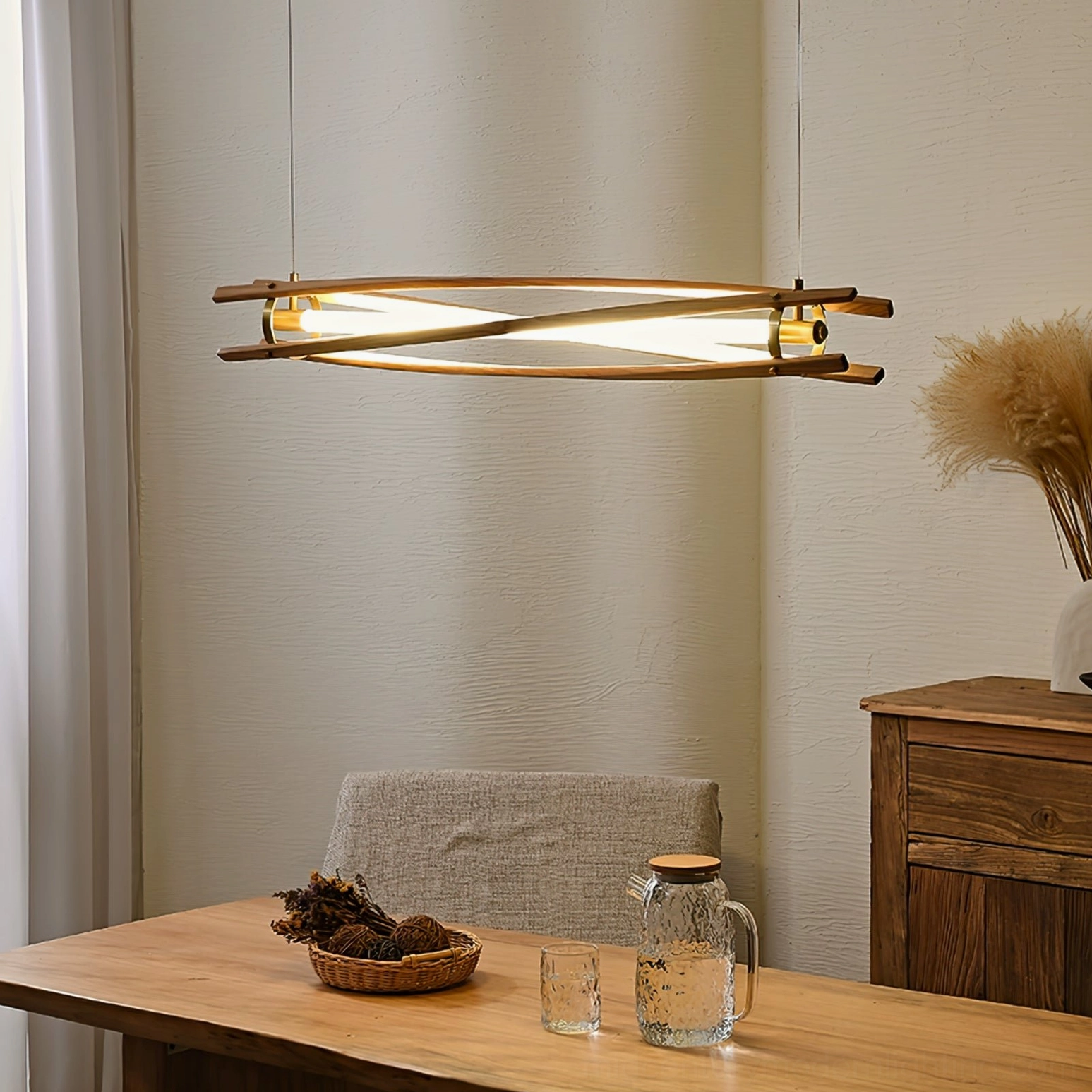 Mid-century modern wood chandelier in compact dining nook with dried floral table styling and warm lighting