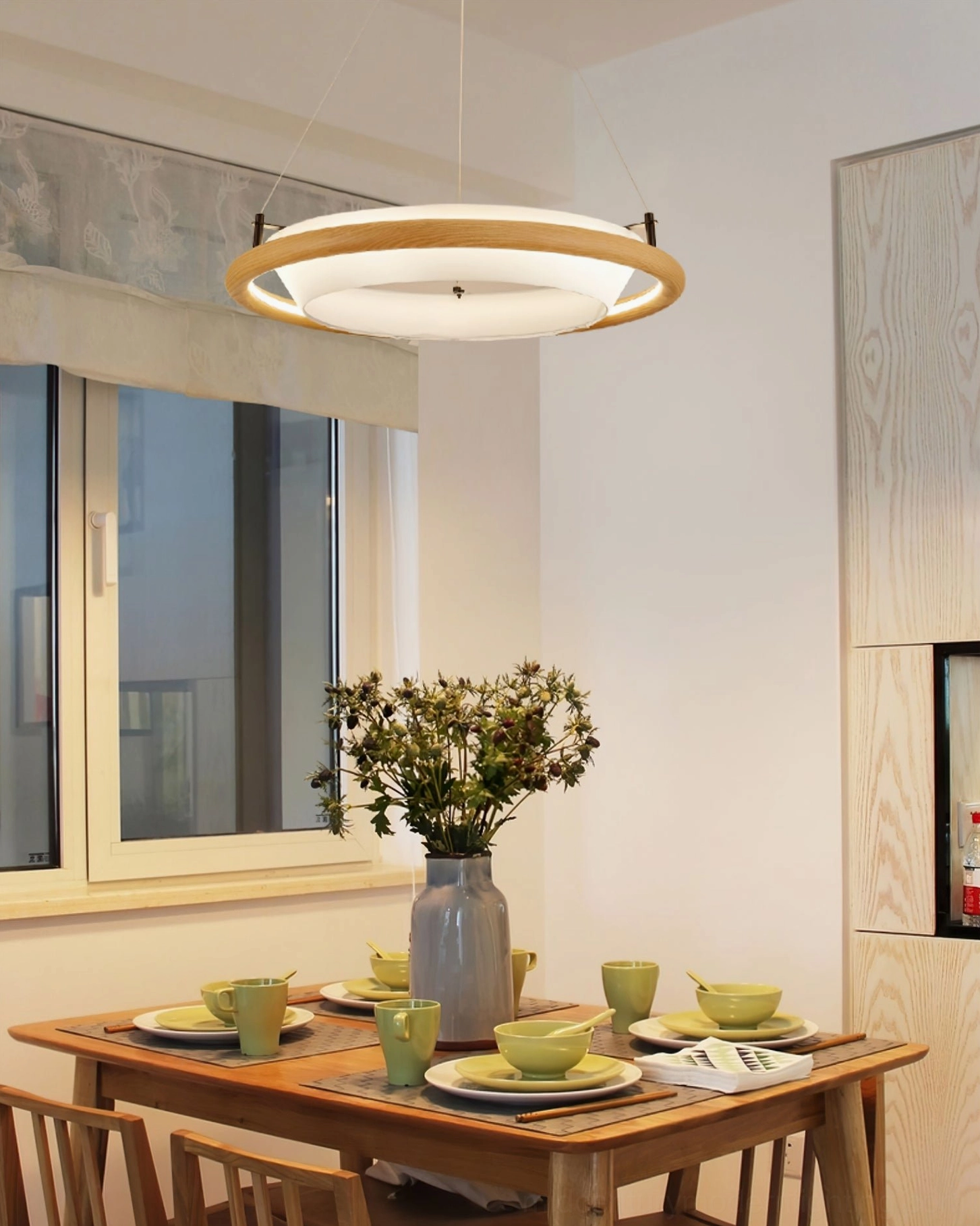Azria wood chandelier in modern dining room - eye-level interior view with wooden dining set and warm ambient lighting
