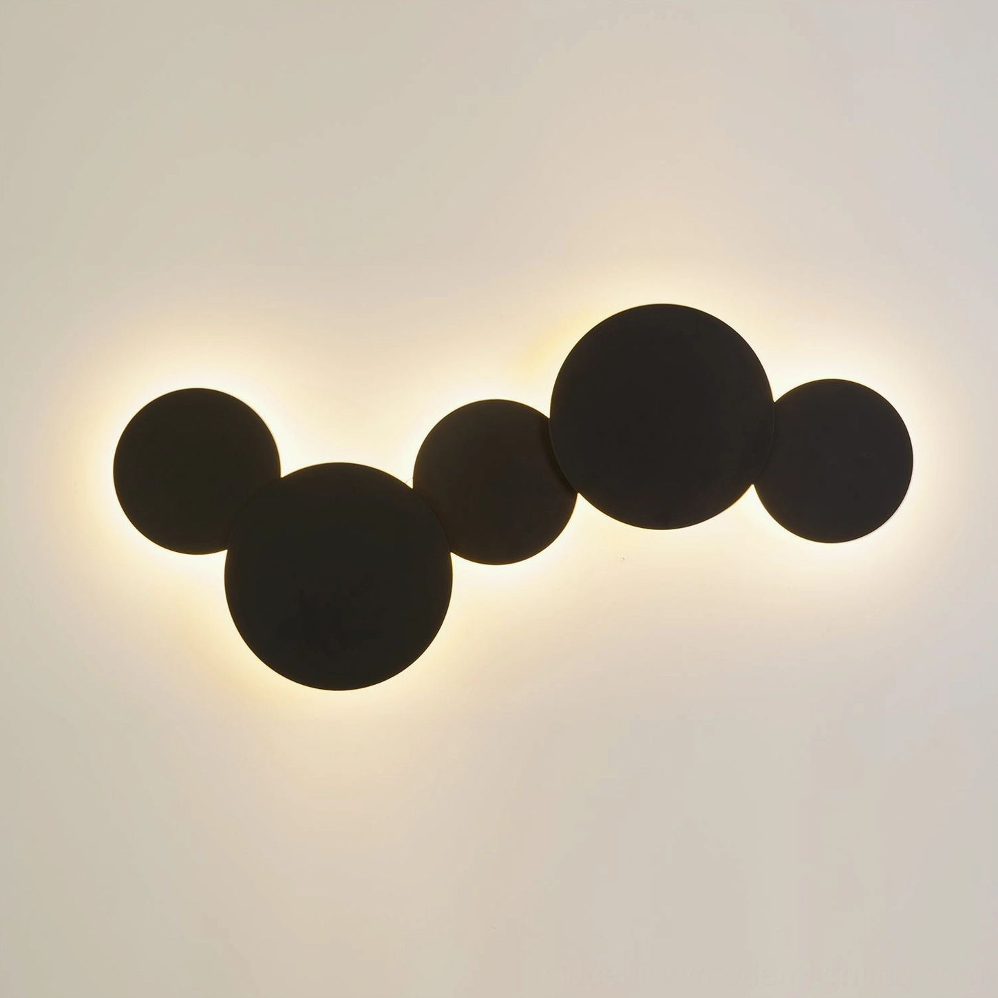Backlit geometric disc wall lamp highlighting sculptural shadow patterns and diffused warm light effect in minimalist space
