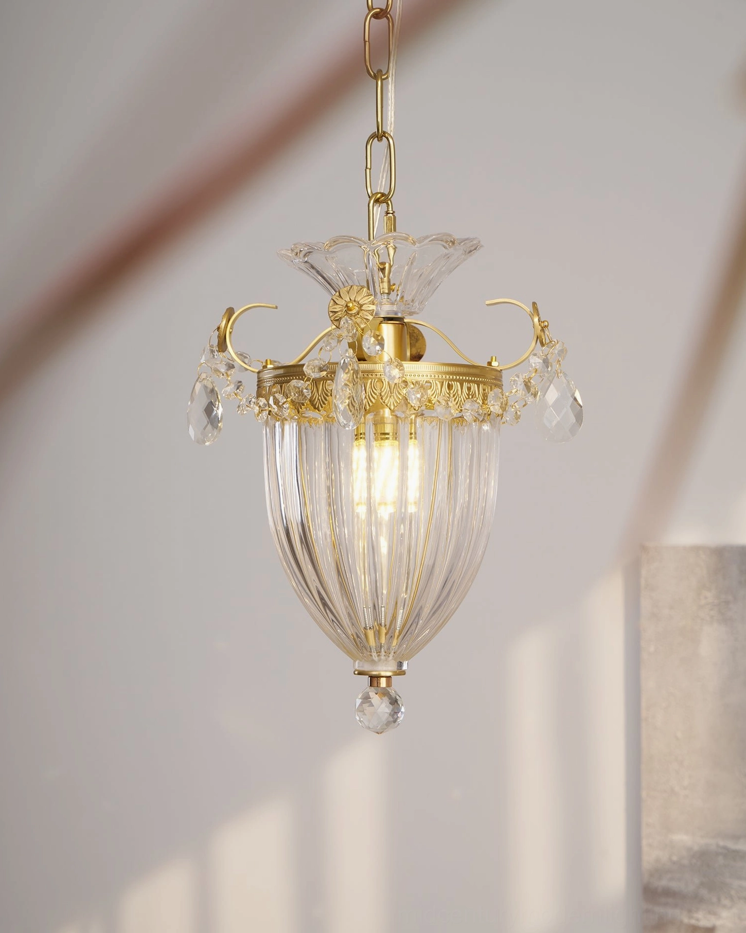 Bagatelle crystal pendant lamp hanging side view with warm ambient light