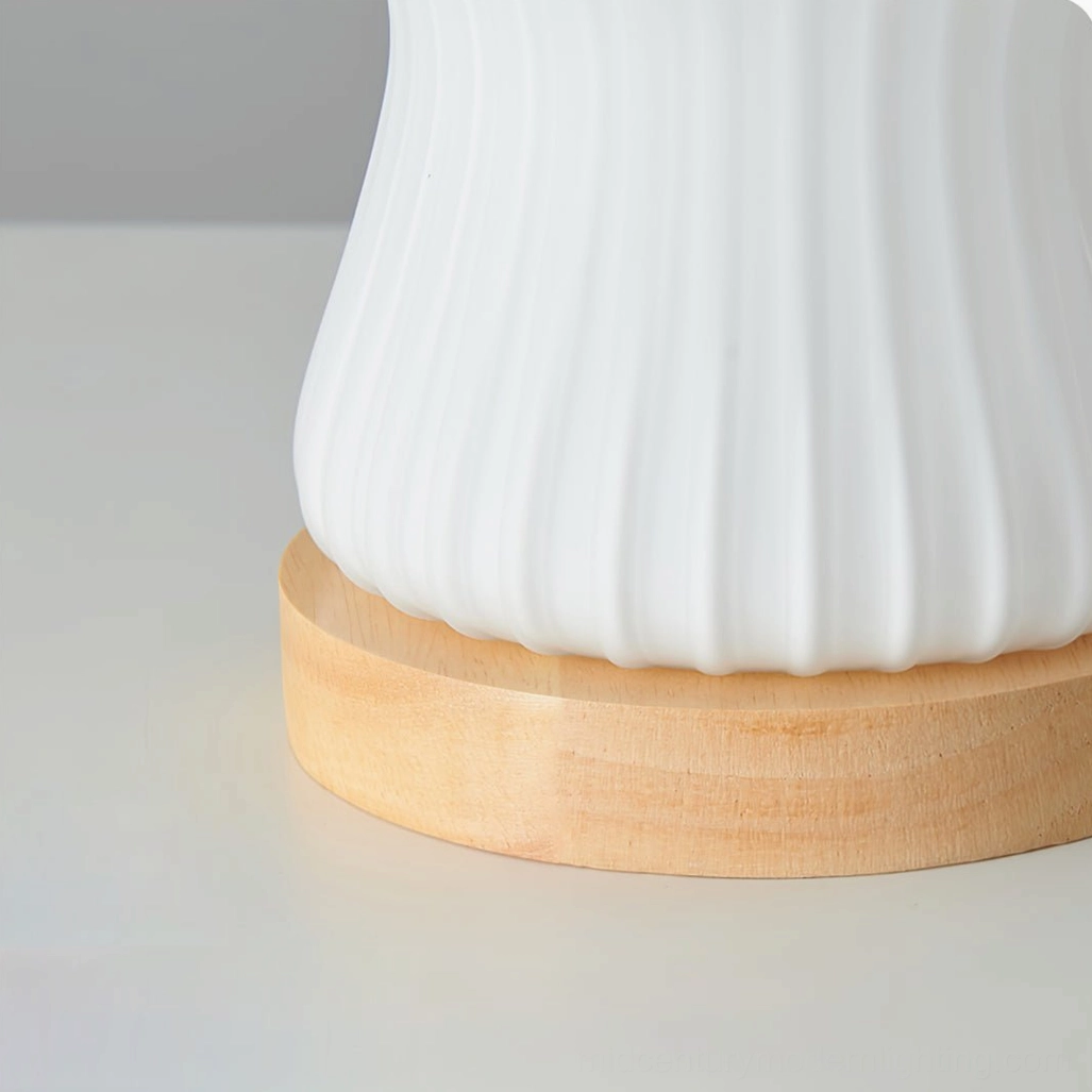 Baja table lamp three-quarter view showcasing glass diffusion and wood base craftsmanship