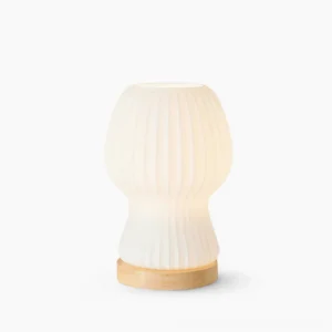 Baja pleated glass table lamp with natural wood base on white background, modern mid-century design