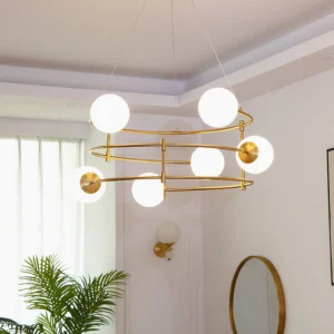 Illuminated hanging sphere chandelier with dual brass rings and frosted white glass bulbs in bright living room