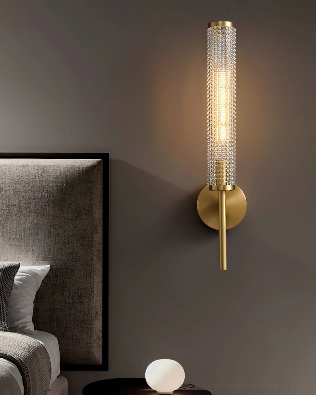 Baldassare brass wall sconce frontal view showing matte gold finish and glass diffuser