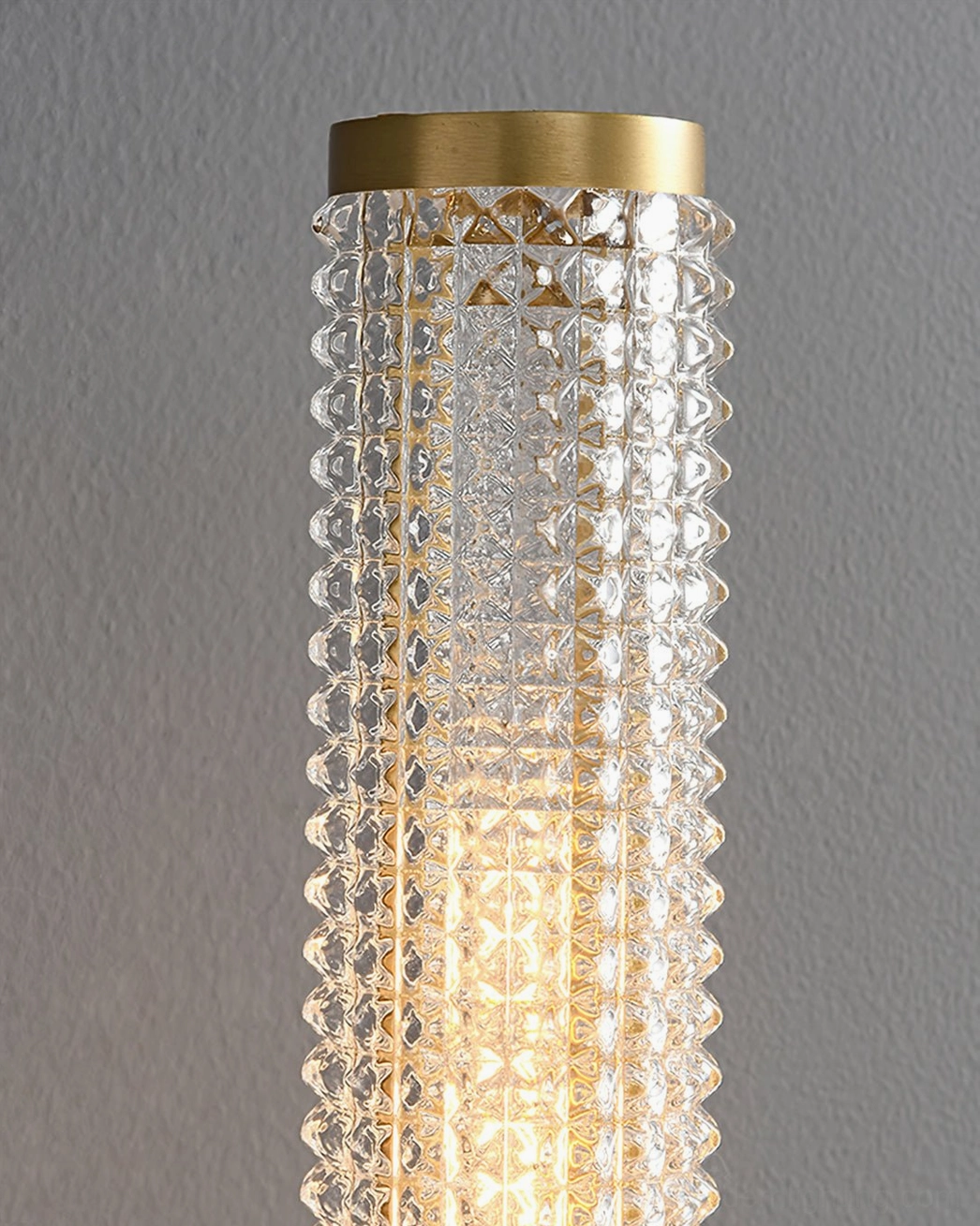 Baldassare brass wall sconce product shot plain backdrop