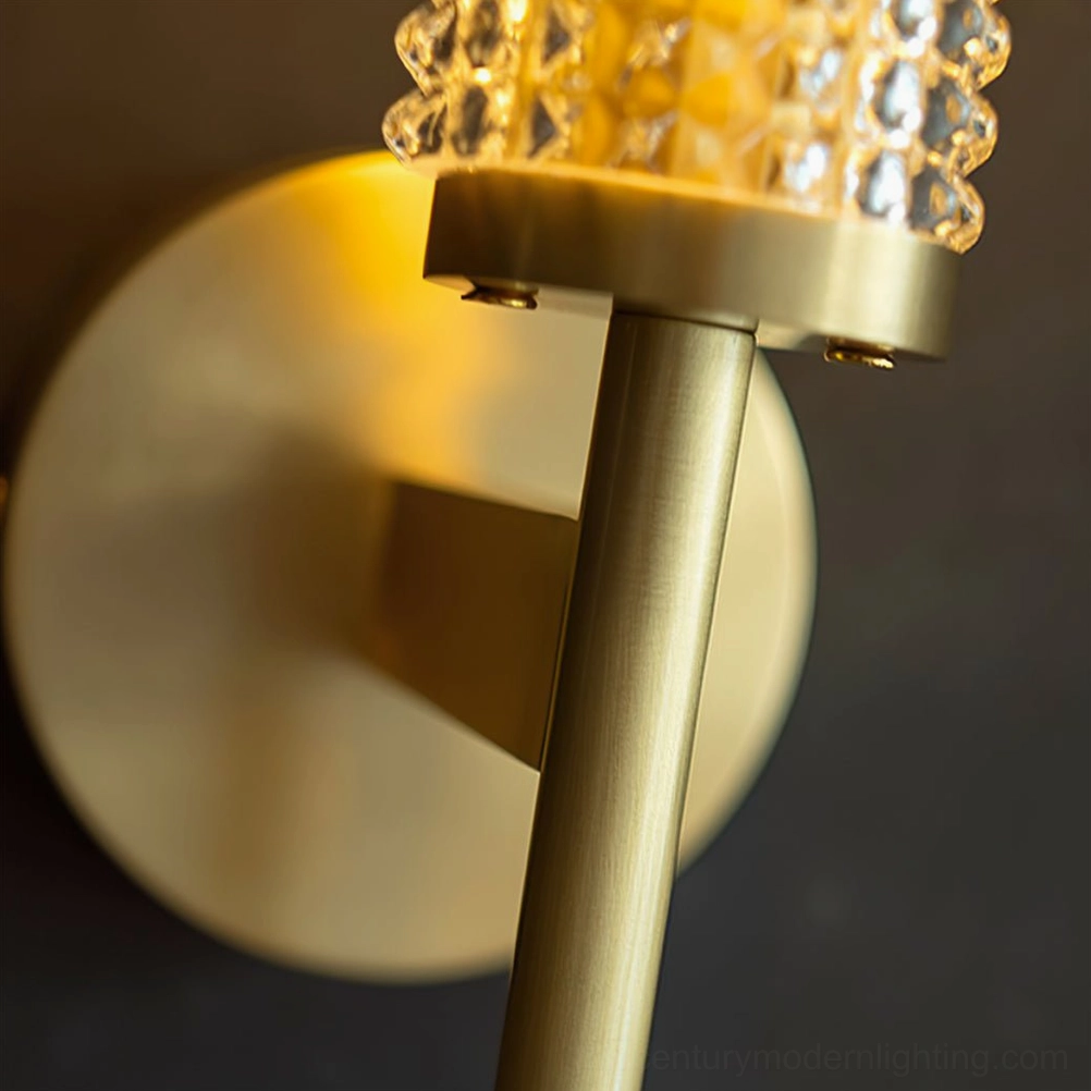 Baldassare matte brass wall lamp showing textured glass shade design