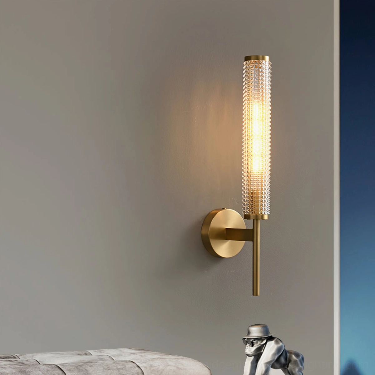 Baldassare cylindrical sconce creating warm light in modern bedroom accent wall