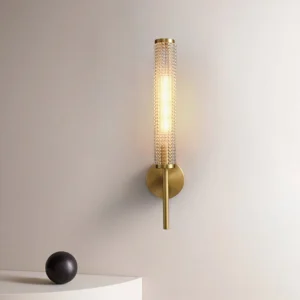 Baldassare wall lamp lit in bedroom bedside setting with warm ambient glow