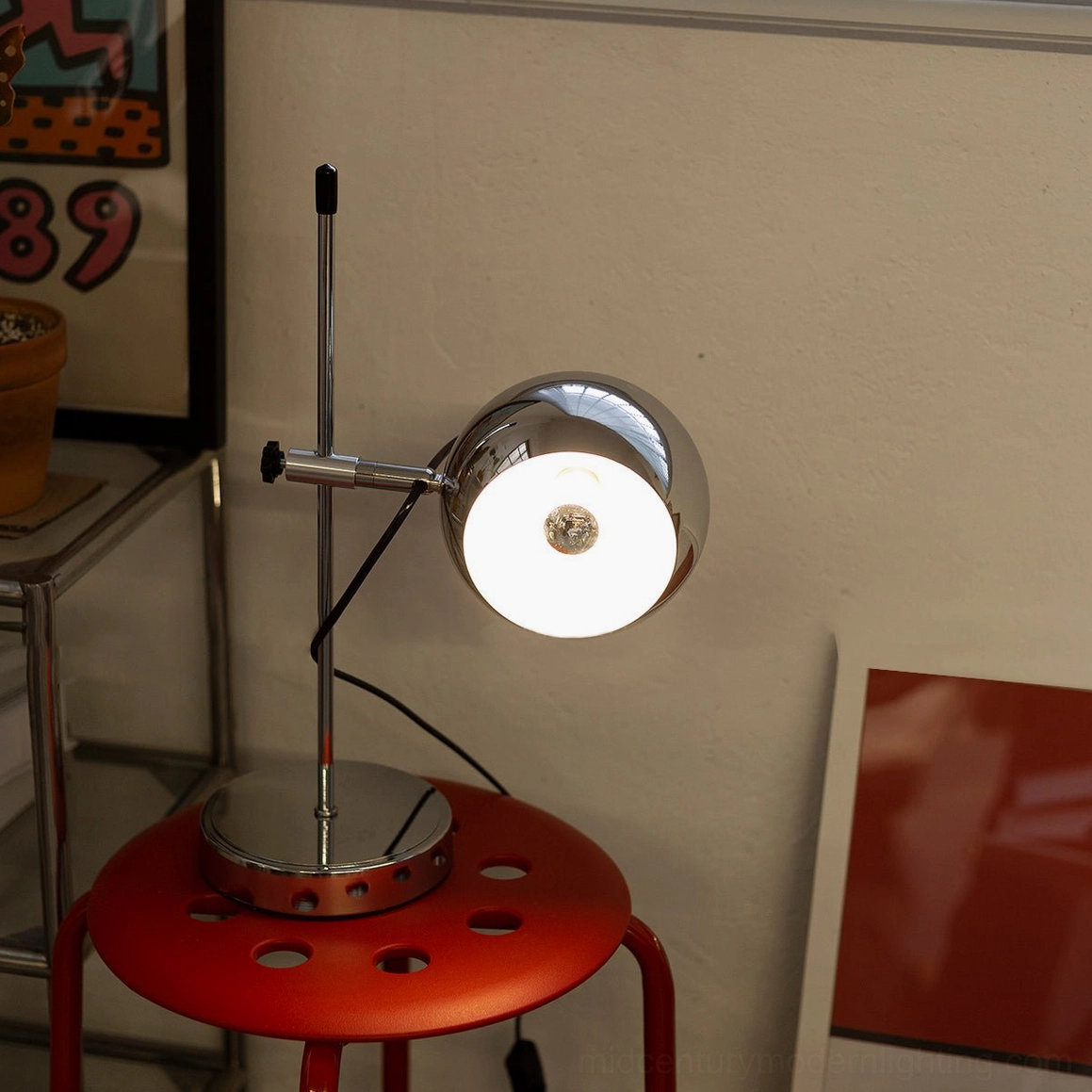 Ball bracket table lamp design detail showing spherical shade and adjustable bracket mechanism