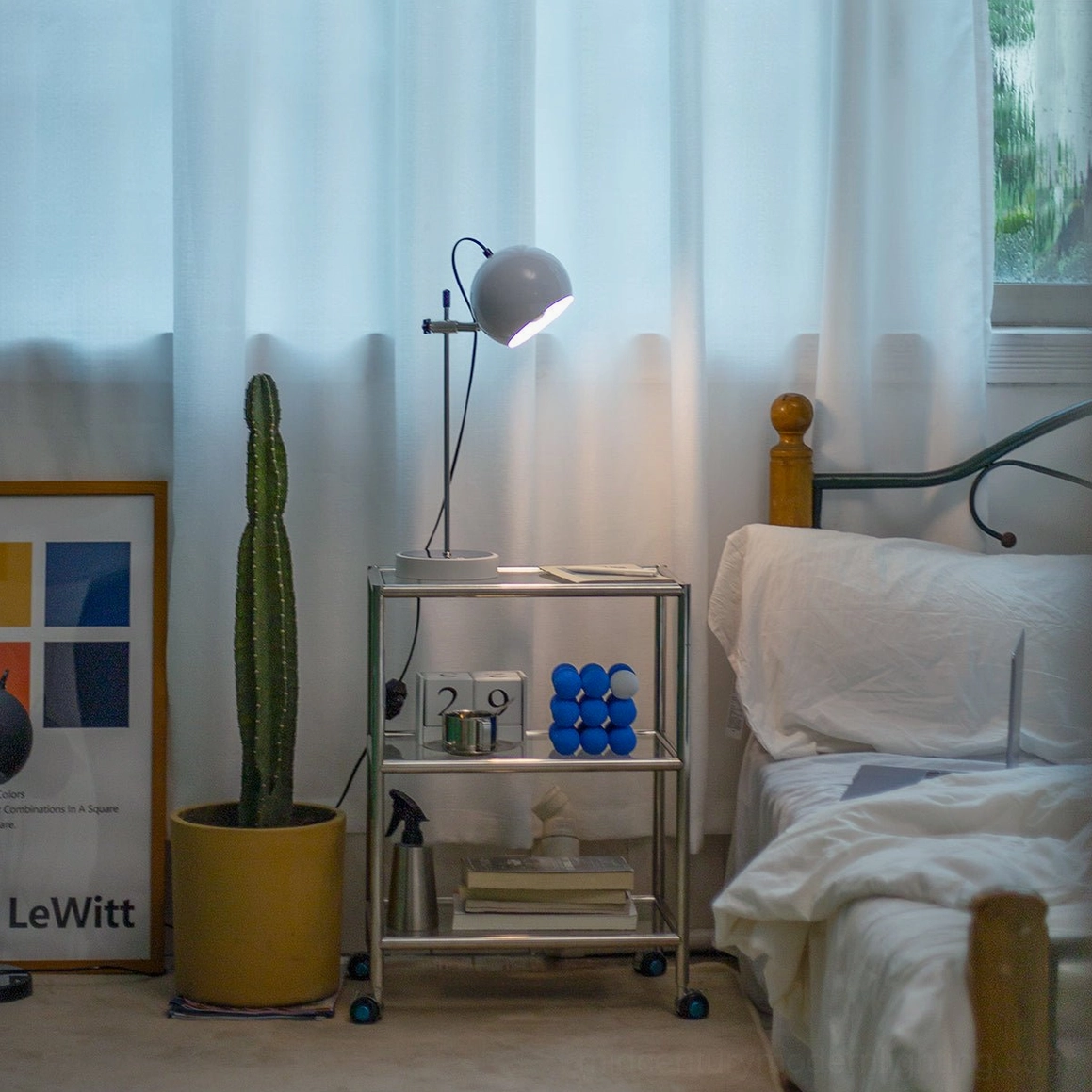 Minimalist ball bracket table lamp accent lighting in curated interior design space