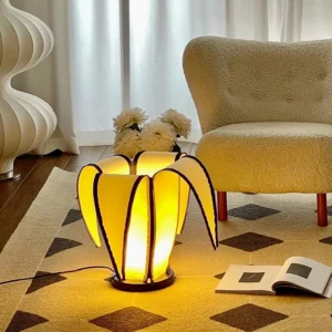 Modern banana-shaped table lamp in Nordic living room setting with warm ambient lighting