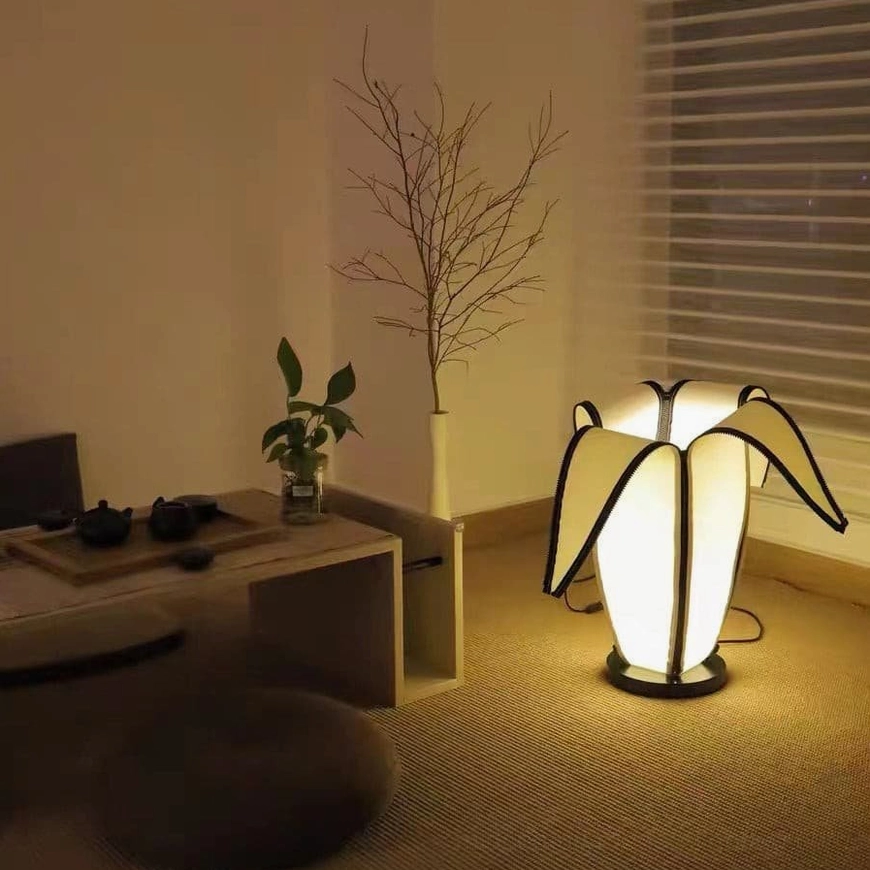 Banana-shaped desk lamp creating ambient glow in Scandinavian-style living room interior