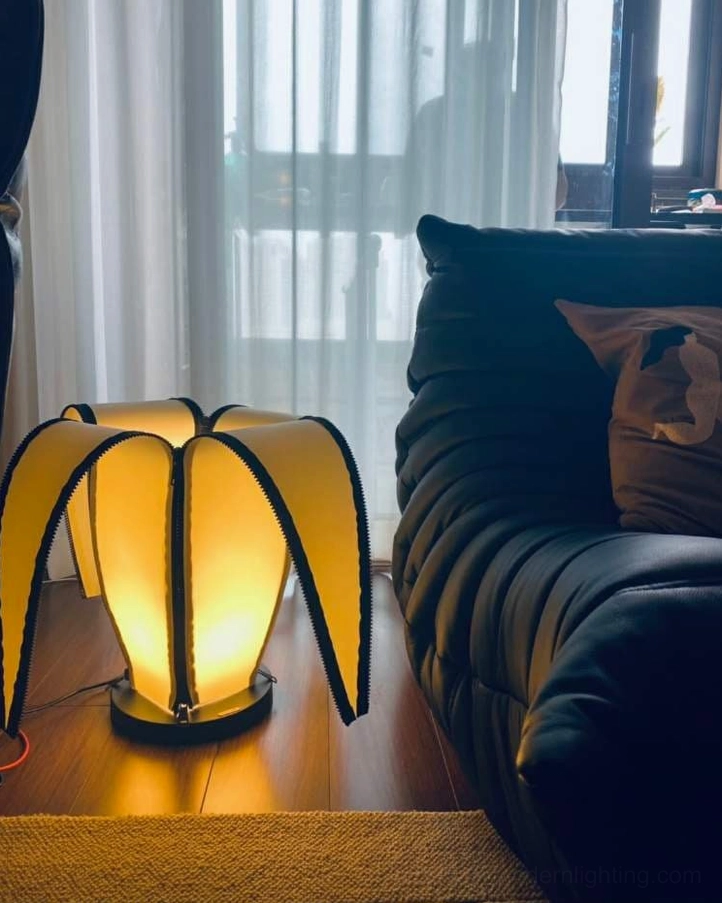 Banana table lamp creating warm pools of light in contemporary bedroom sanctuary space