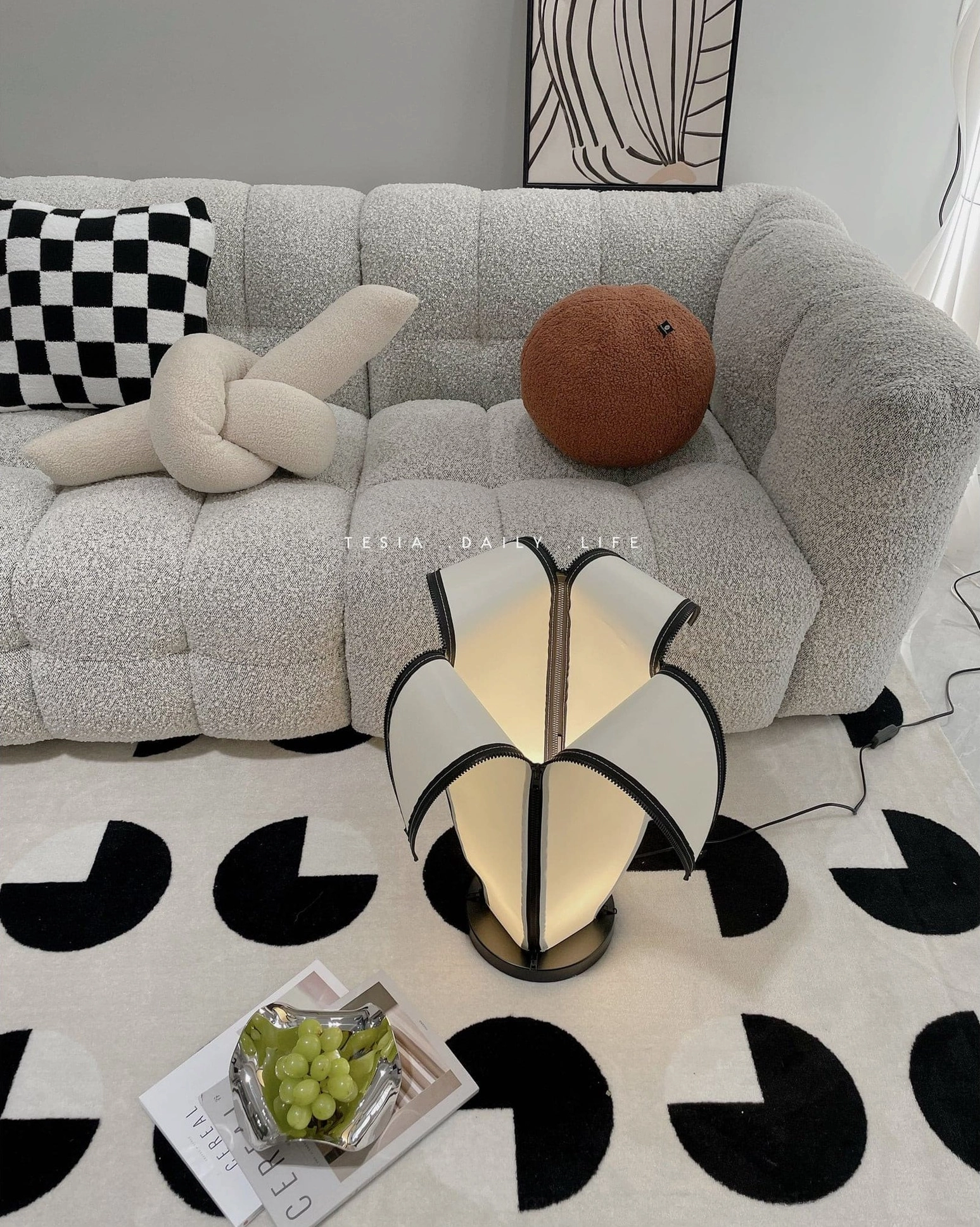 Sculptural banana lamp accent lighting on geometric patterned rug in contemporary living space