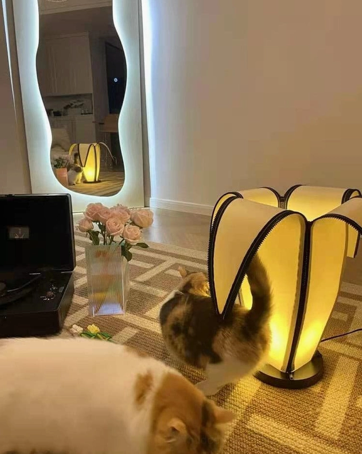 Contemporary banana-style desk lamp with black base casting warm yellow light in modern living room