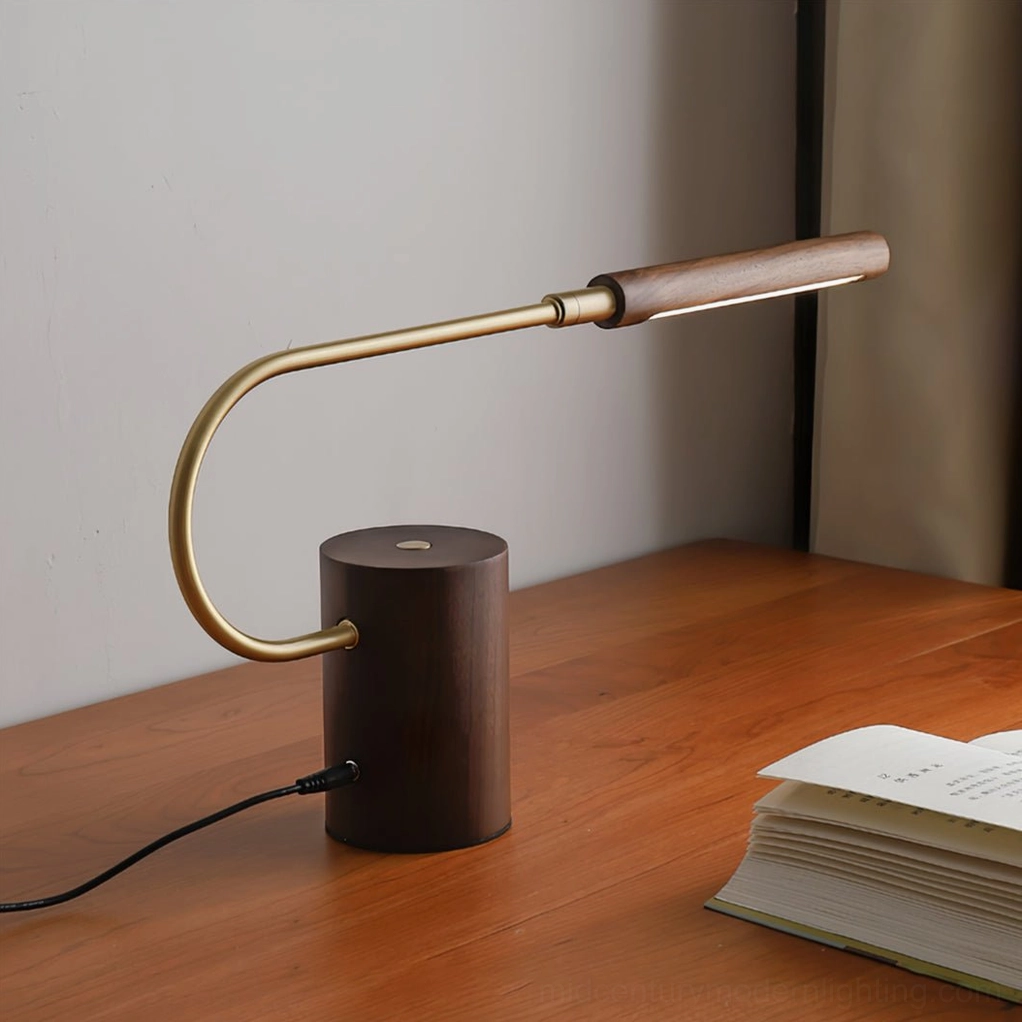 Banker Slim table lamp on wooden study desk with open reading book, three-quarter angle view