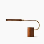 Banker Slim LED table lamp with walnut wood base and brass accents, side profile view on white background