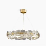 Barclay textured glass chandelier with brass ring frame - front studio view showing lotus-petal glass design and warm gold lighting