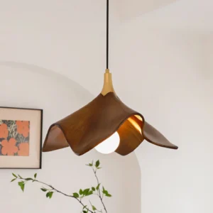 Bark pendant light illuminated in cozy interior setting with wall art and rustic decor, showcasing warm downward glow and exposed bulb aesthetic