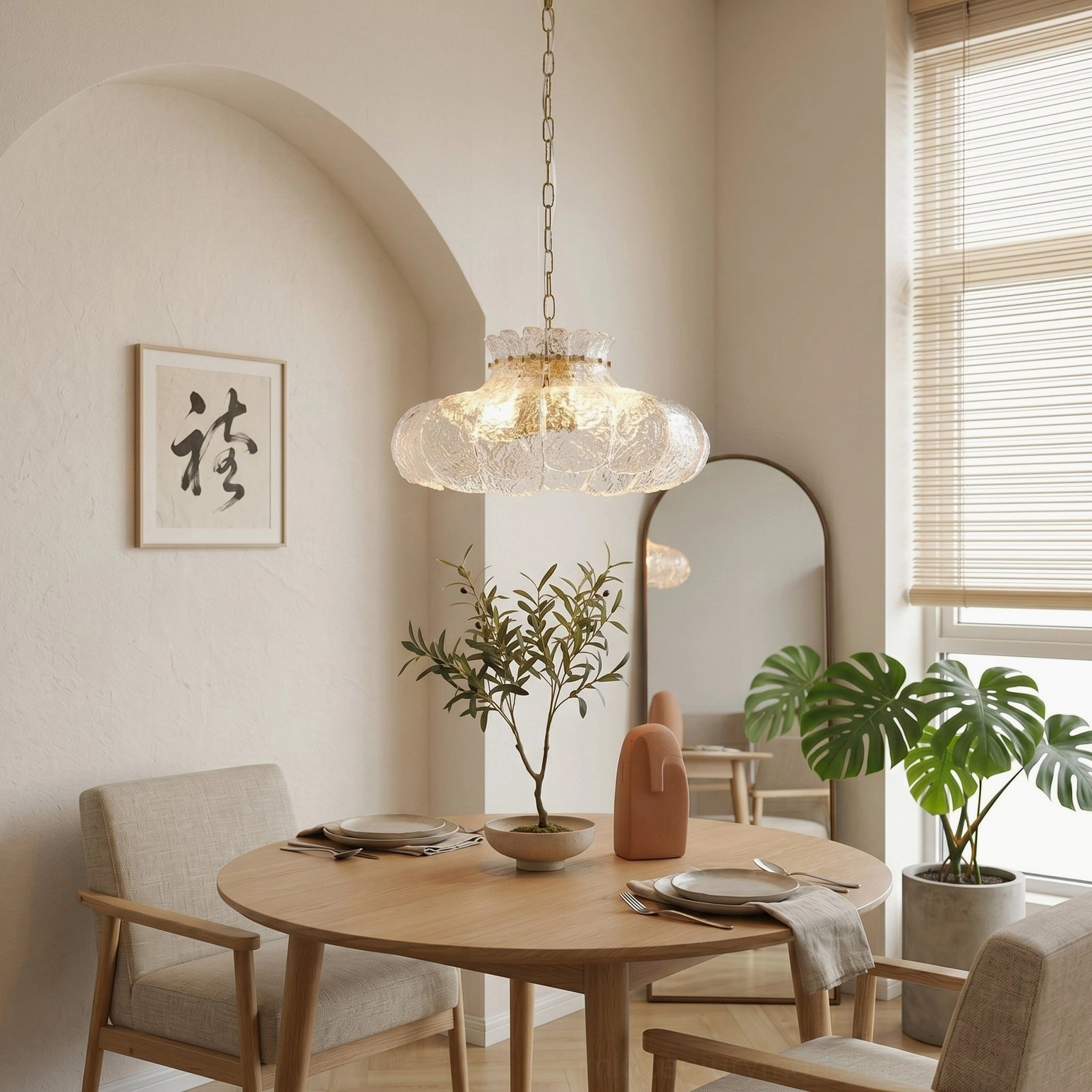 Barlas scalloped glass chandelier hanging in minimalist dining nook, three-quarter side view with warm neutral home decor