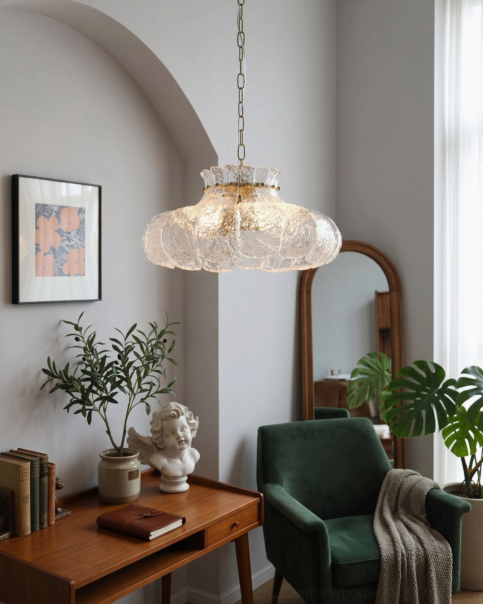 Barlas pendant light in cozy reading corner with green velvet armchair, arched mirror, and potted foliage
