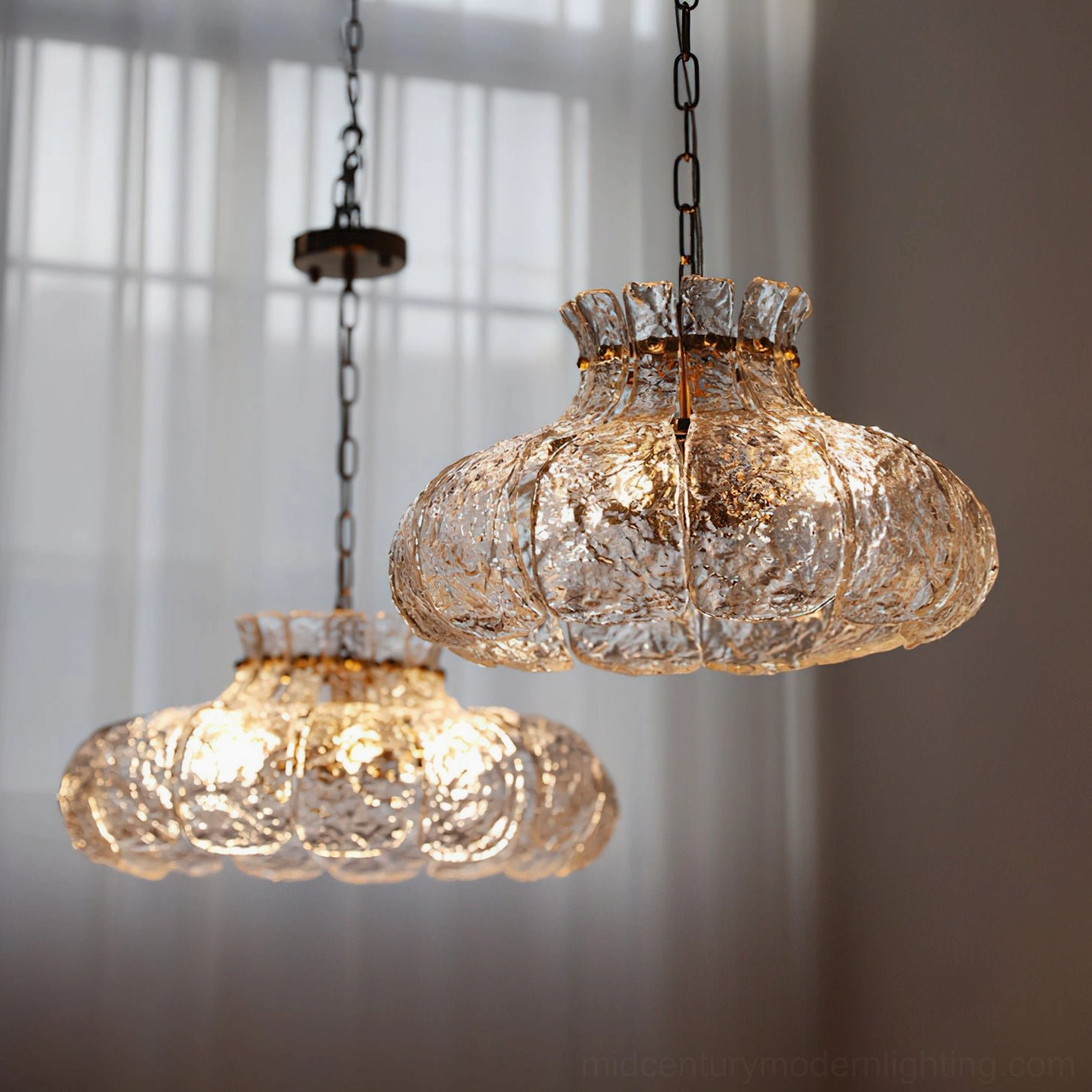 Barlas pendant light installed in contemporary dining setting with modern furnishings and warm ambient glow