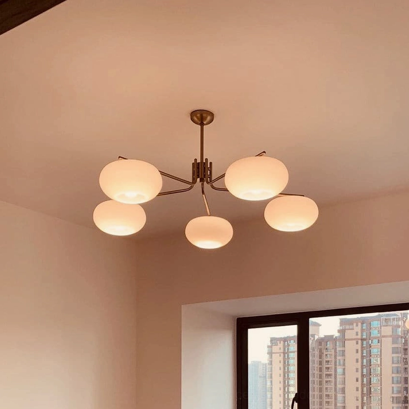 Barndon 5-head spherical glass chandelier in residential bedroom with window, dark bronze frame and frosted glass diffusers
