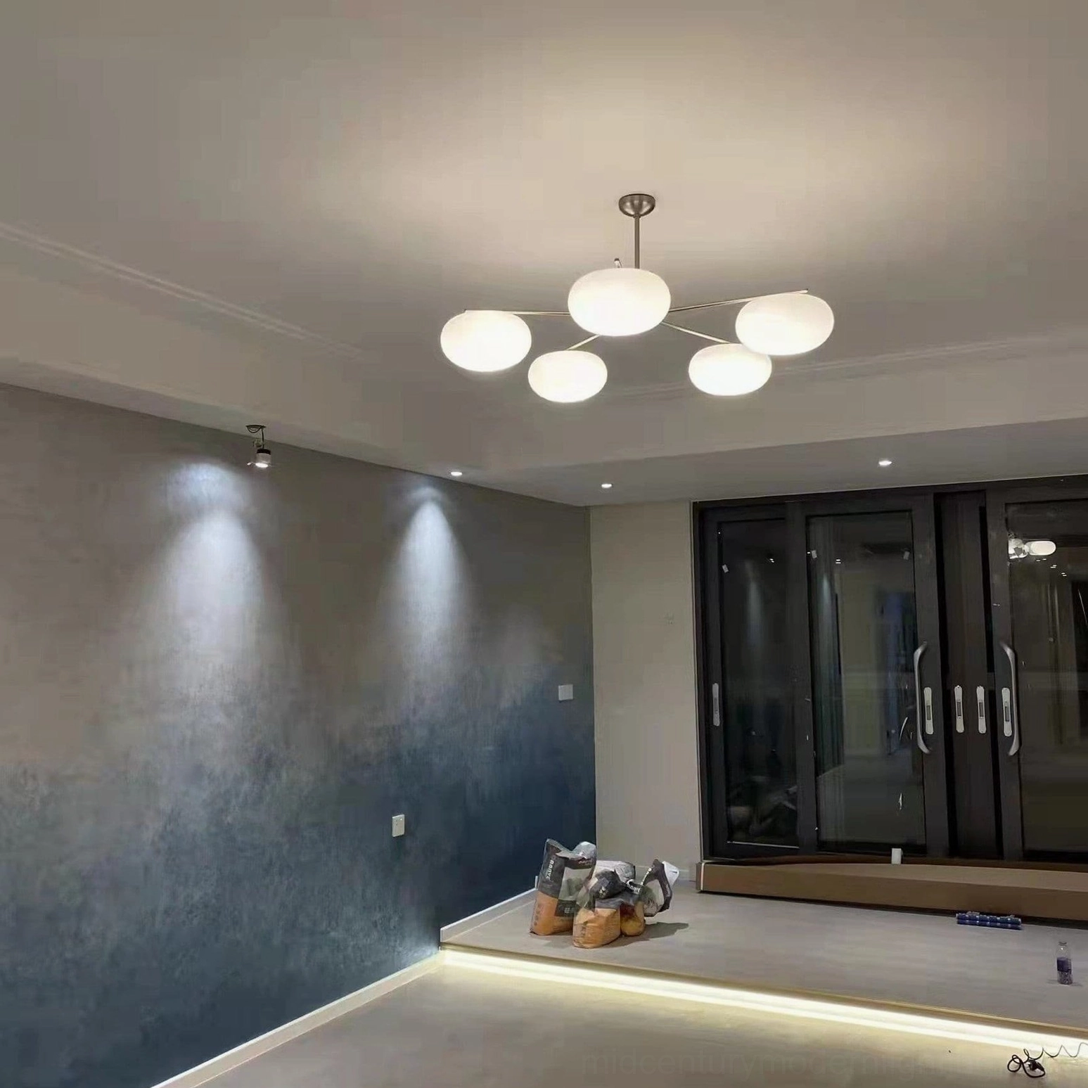 Barndon 6-head frosted glass chandelier in contemporary dining area, eye-level room view with warm white ambient lighting and minimalist design