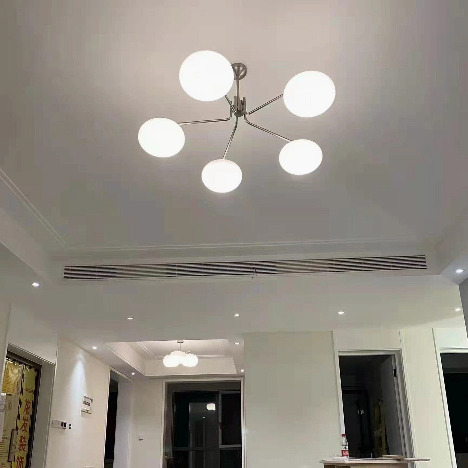 Barndon frosted glass pendant chandelier in contemporary kitchen island installation with metal frame
