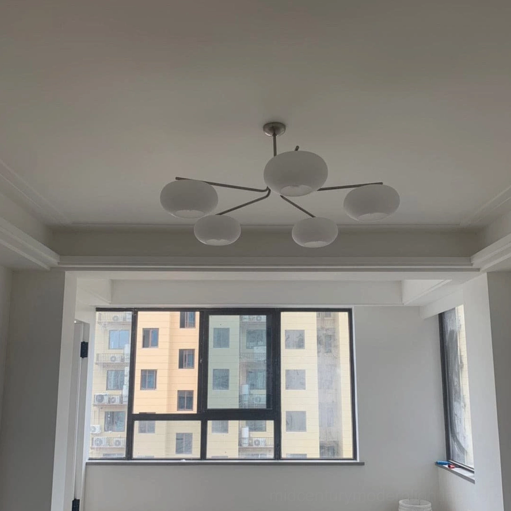 Barndon mid-century modern chandelier silver finish in contemporary interior space with warm neutral palette