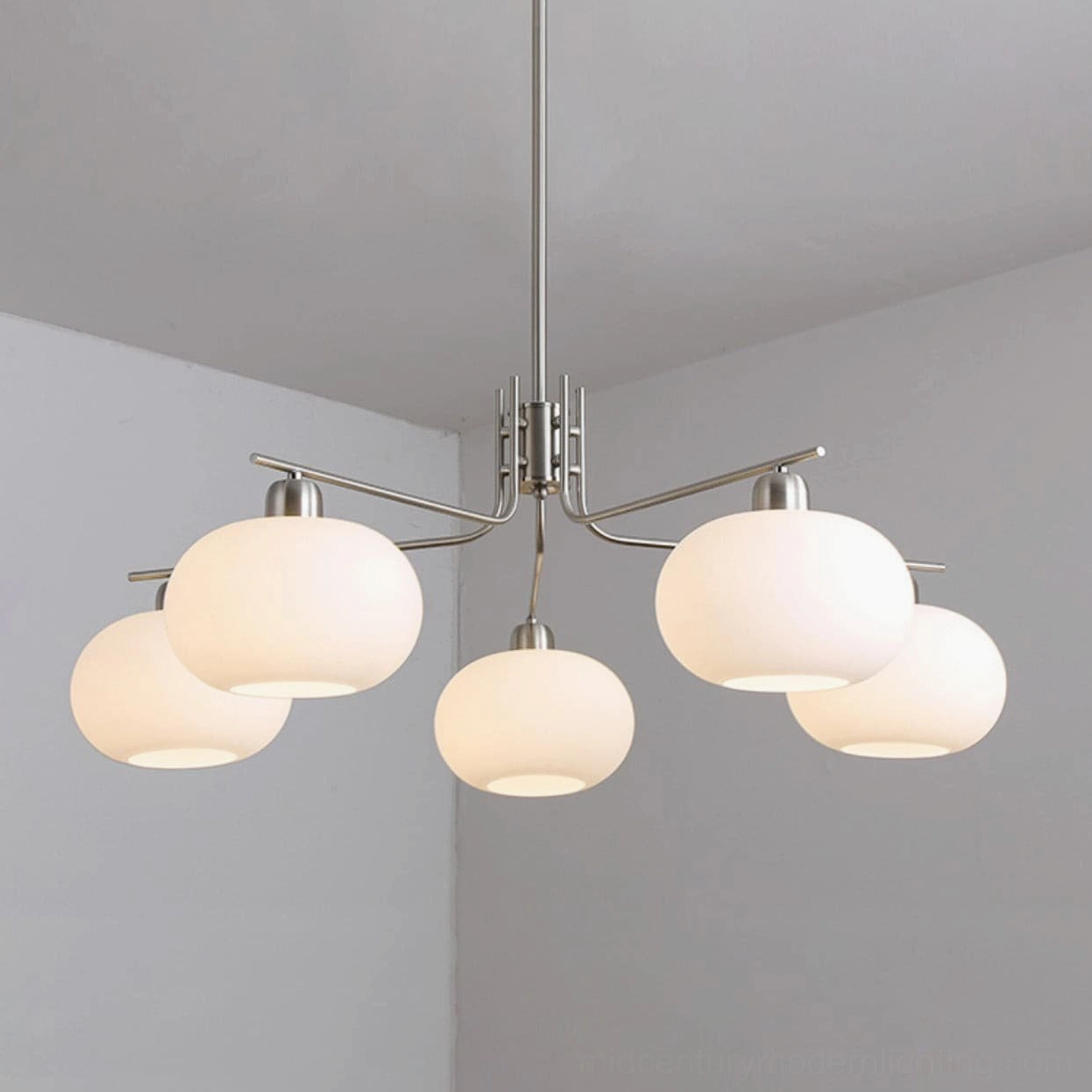 Barndon frosted glass chandelier in eclectic mid-century modern interior design arrangement