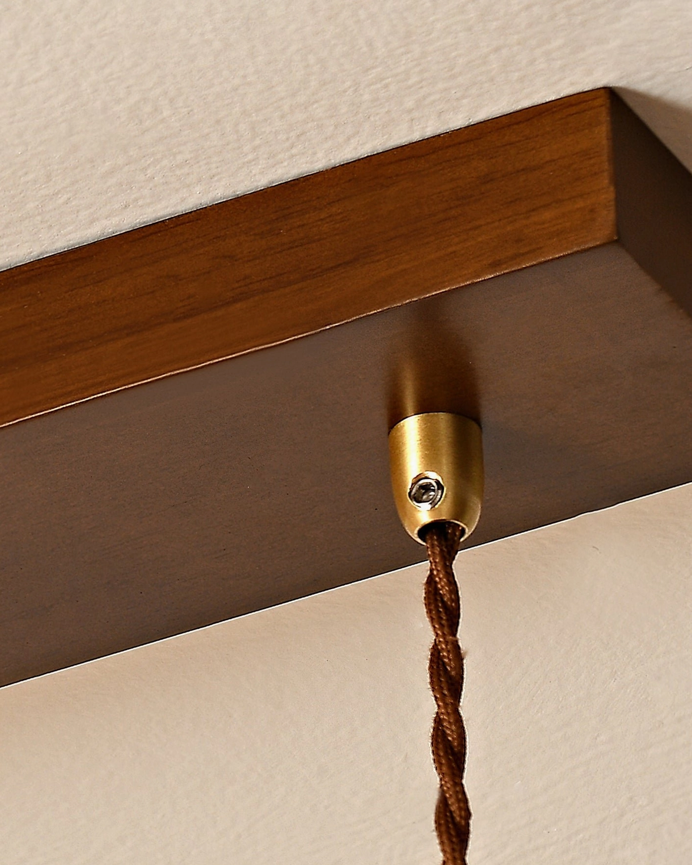 Barron pendant light from below angle showcasing fluted amber glass diffusion and warm glow