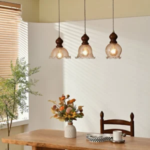 Set of three Barron pendant lights in warm dining room, mid-century modern style with glowing Edison bulbs
