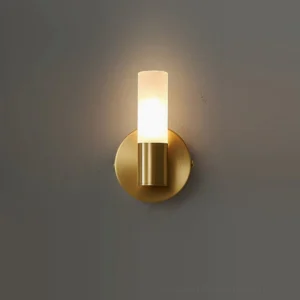Barton small compact wall sconce, 13cm height, brass and white finish mounted on dark gray wall