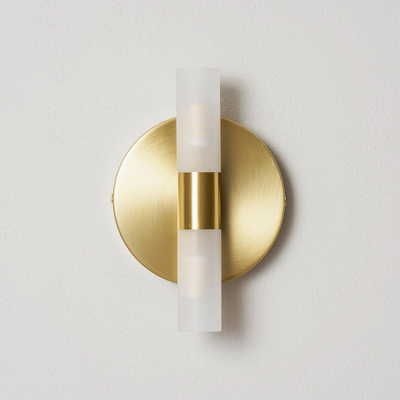 Barton wall sconce in transitional living room, warm minimalist interior styling