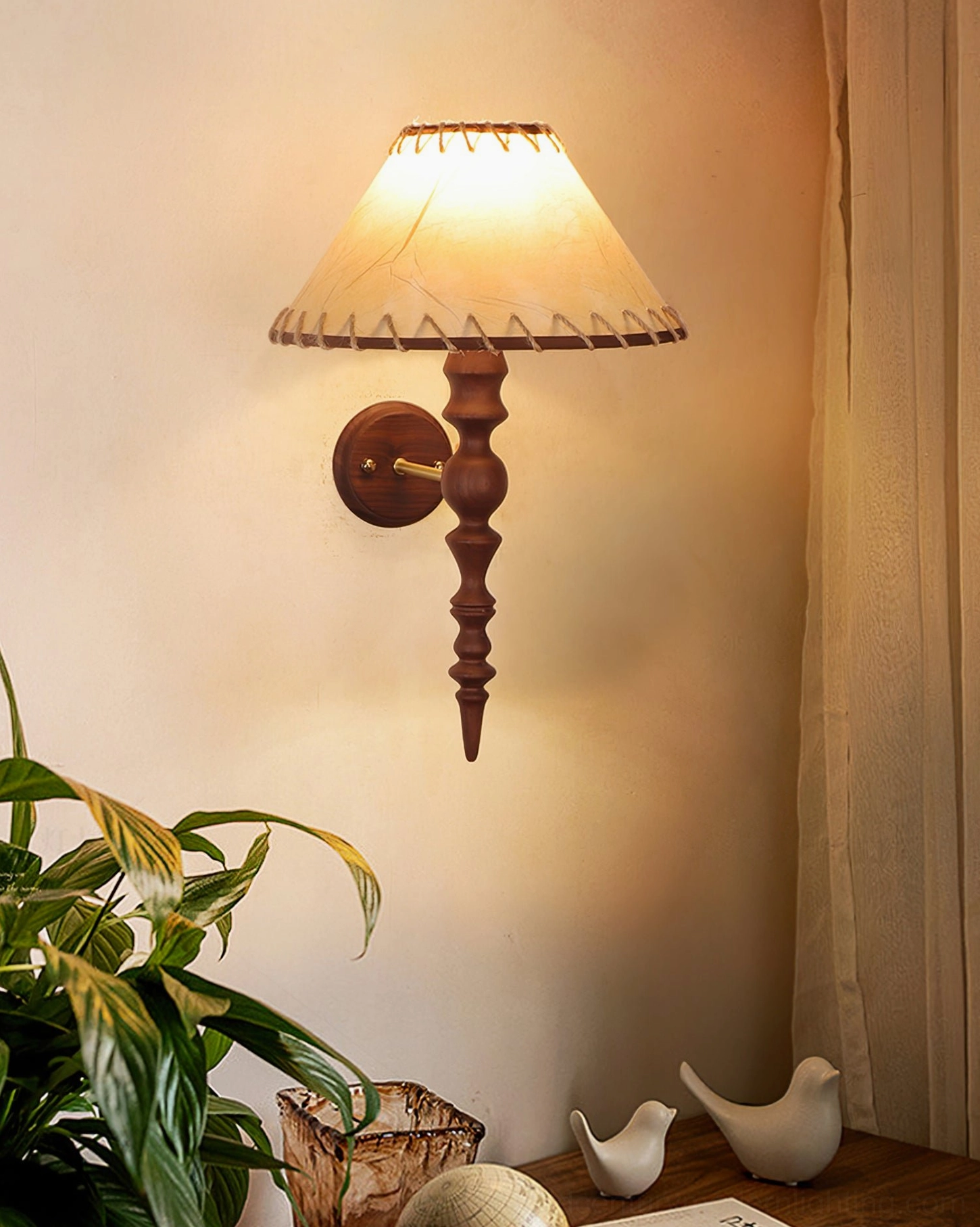 Basica wall lamp in cozy bedroom corner with green plants and bird ornament decor