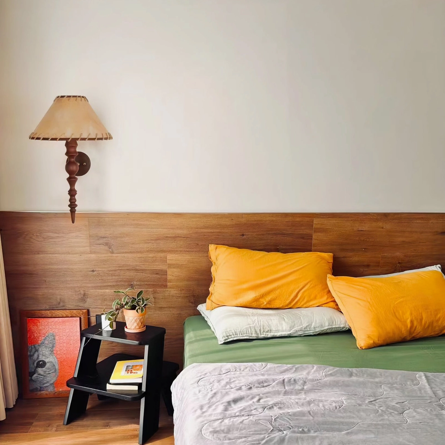Basica wall lamp in double bed bedroom with wooden headboard and bedside shelf styling
