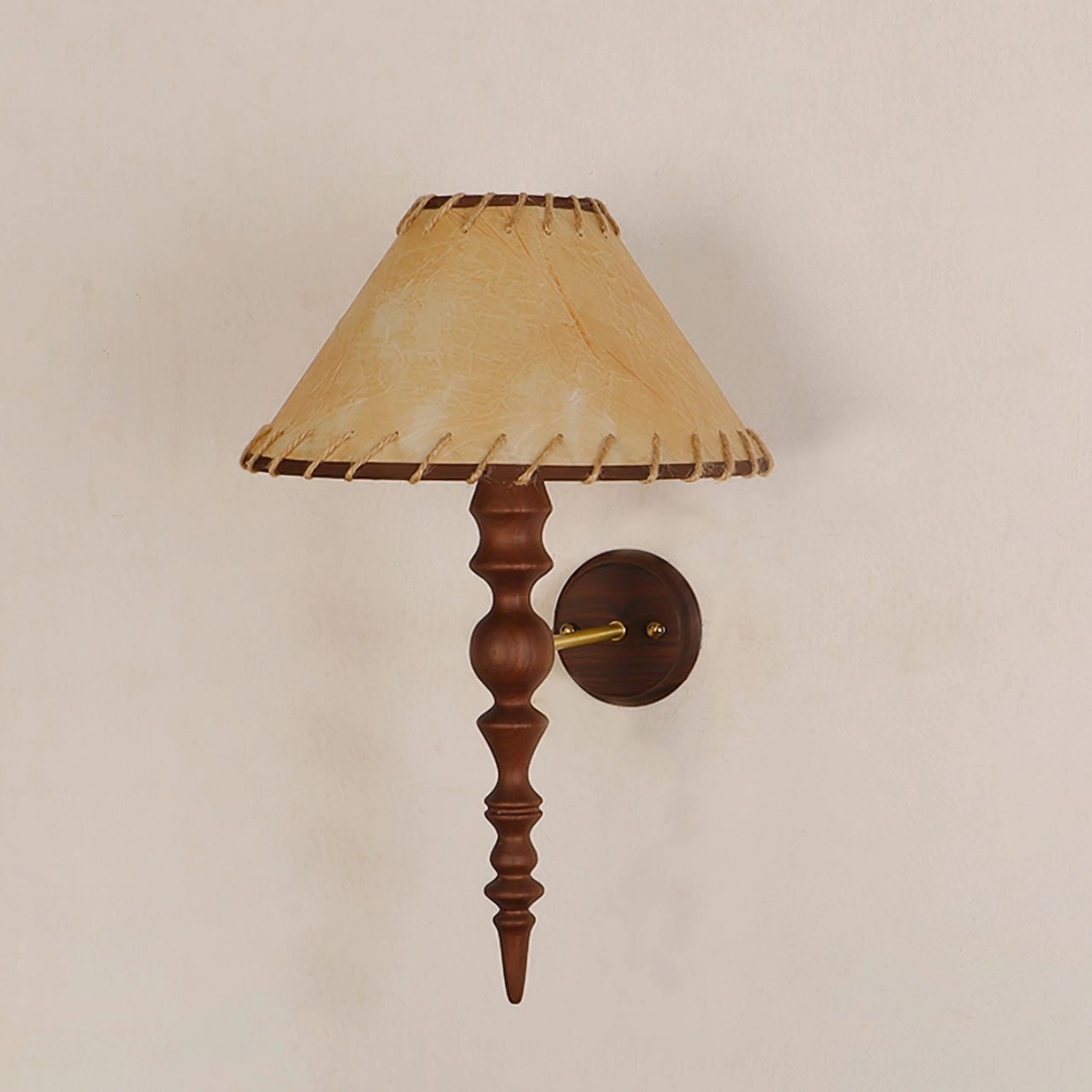 Basica wooden wall lamp close-up showing stitched fabric shade detail and turned wood mounting pole
