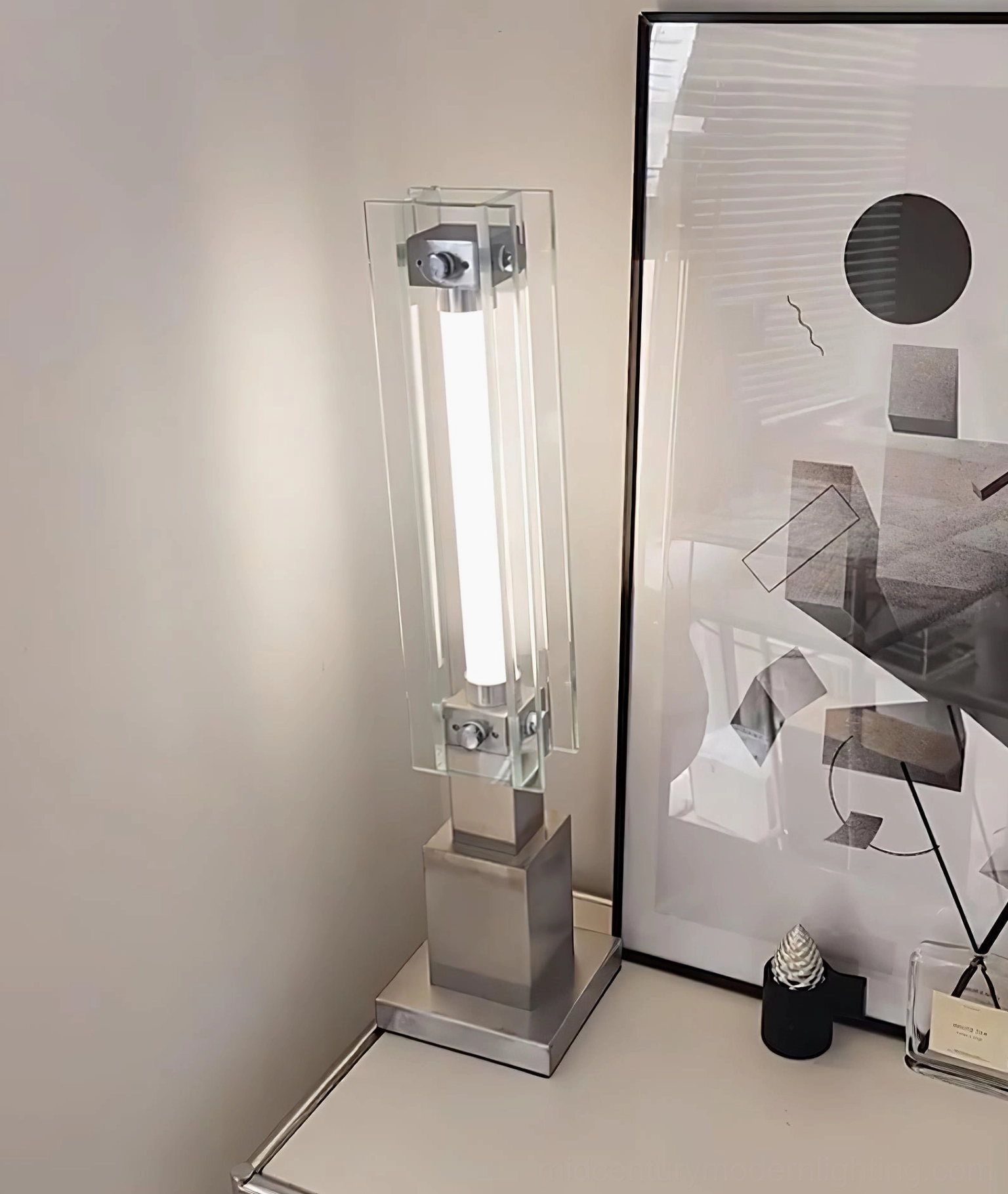 Bauhaus-inspired glass cylinder lamp with brushed stainless steel base architectural composition