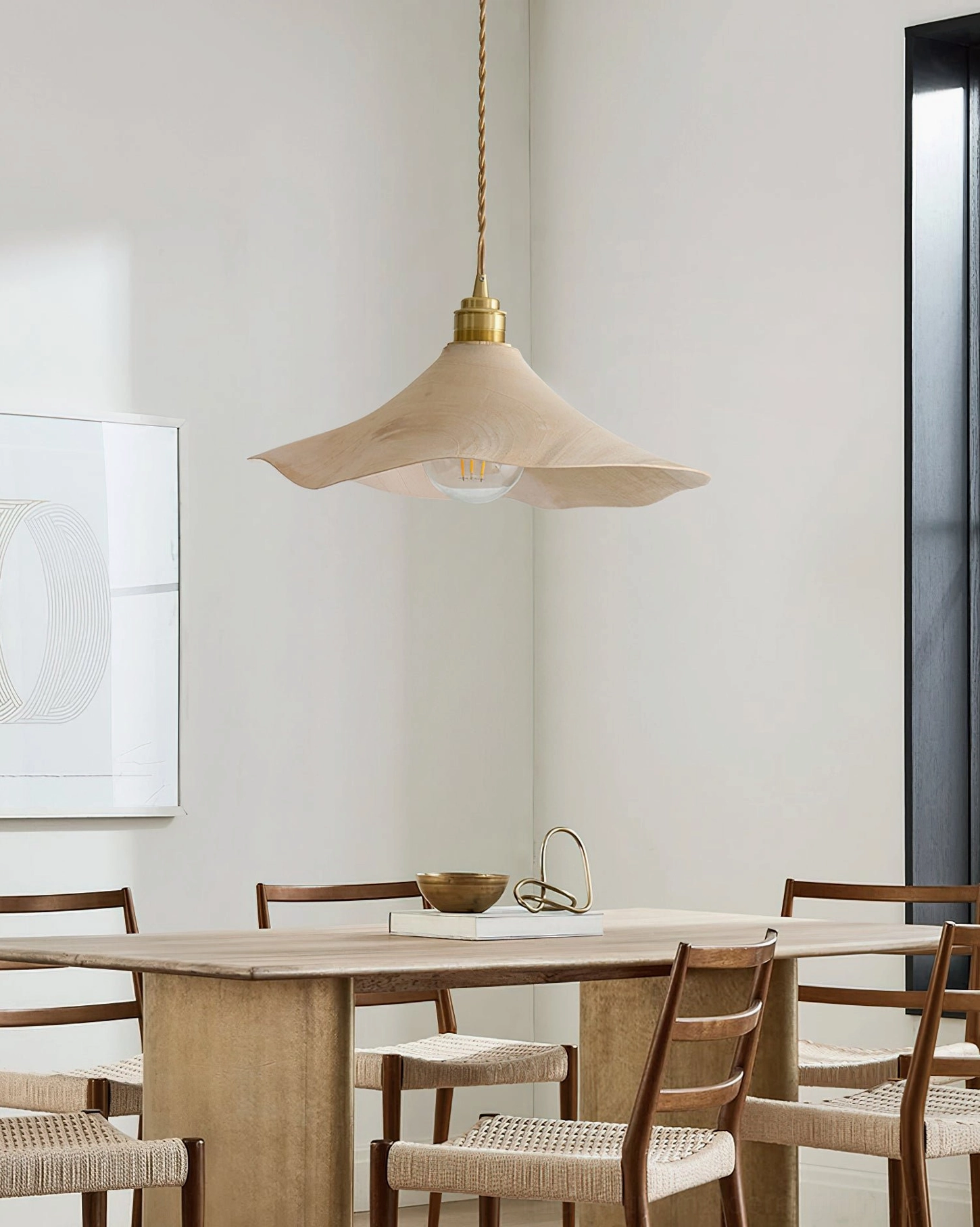 Baxter mid-century modern pendant light installed above dining table in Japanese-style room with warm wooden furniture and neutral decor