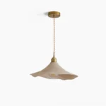 Baxter organic wave pendant light with wavy light beige shade and brass metal fixtures shown from overhead front view in studio lighting