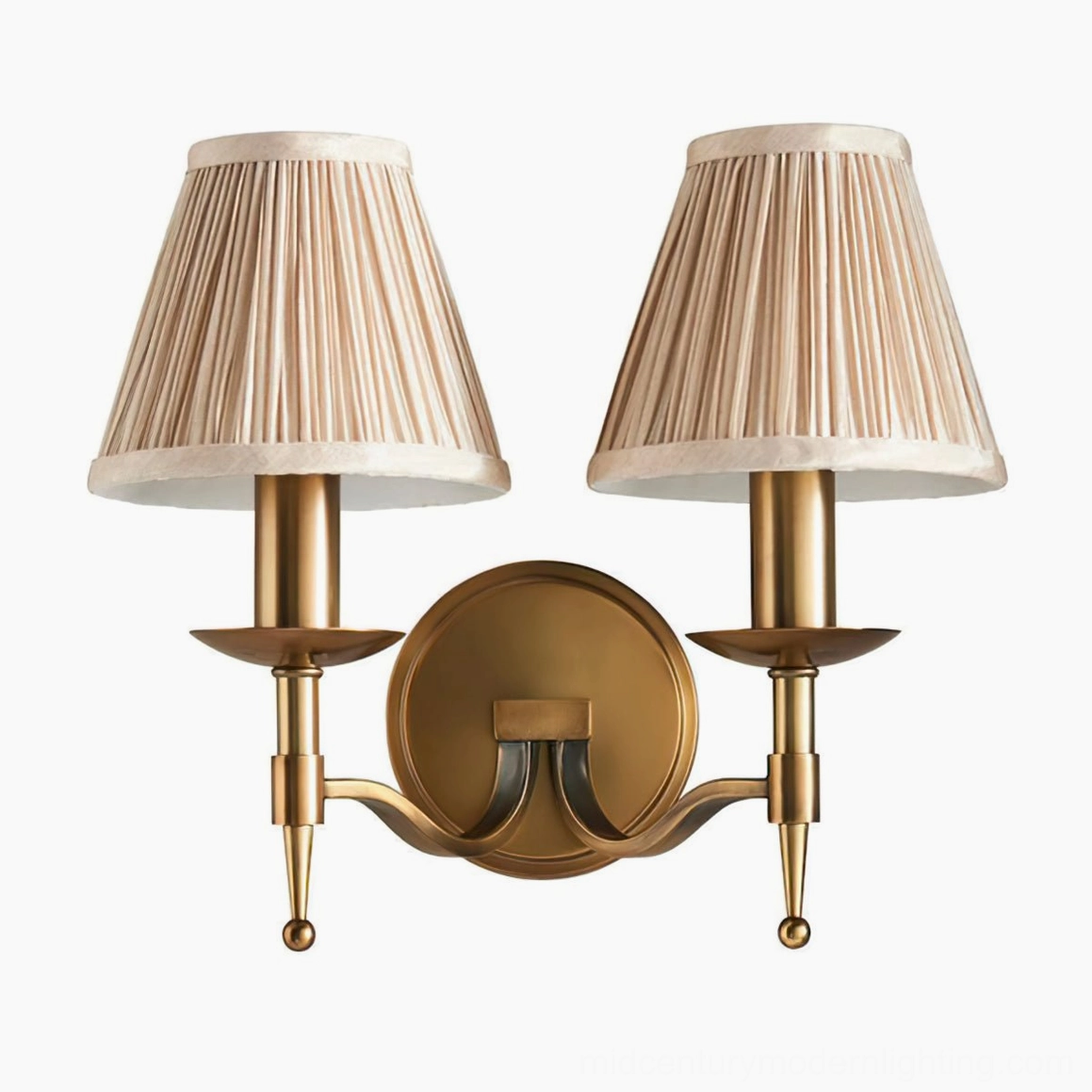 Styled interior shot of Baylor brass wall sconce demonstrating warm ambient light through pleated fabric shade
