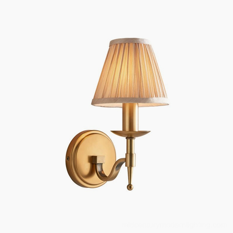 Compact configuration Baylor brass wall sconce with short arm projection ideal for bedside and narrow wall mounting