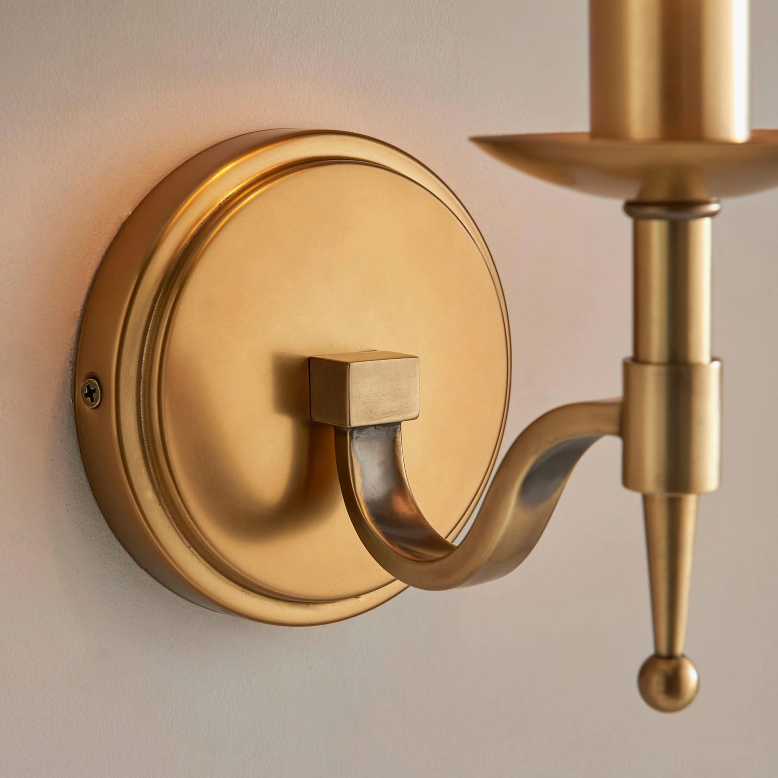 Baylor mid-century modern brass wall sconce mounted in contemporary interior space with neutral styling