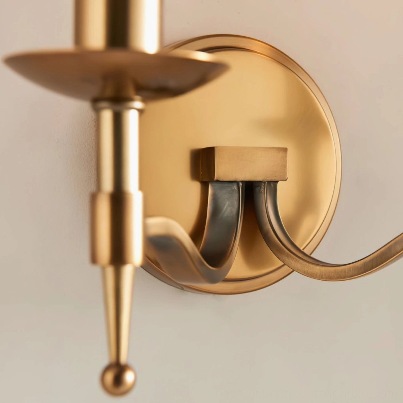 Close-up of Baylor wall sconce showing square mounting block and turned brass detailing of the fixture assembly