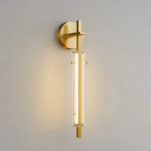 Polished brass Beacon wall lamp illuminated, showing warm-white LED light diffusing through ribbed glass