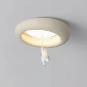 Close-up of adorable white bear figurine suspended from textured ring frame of modern ceiling light