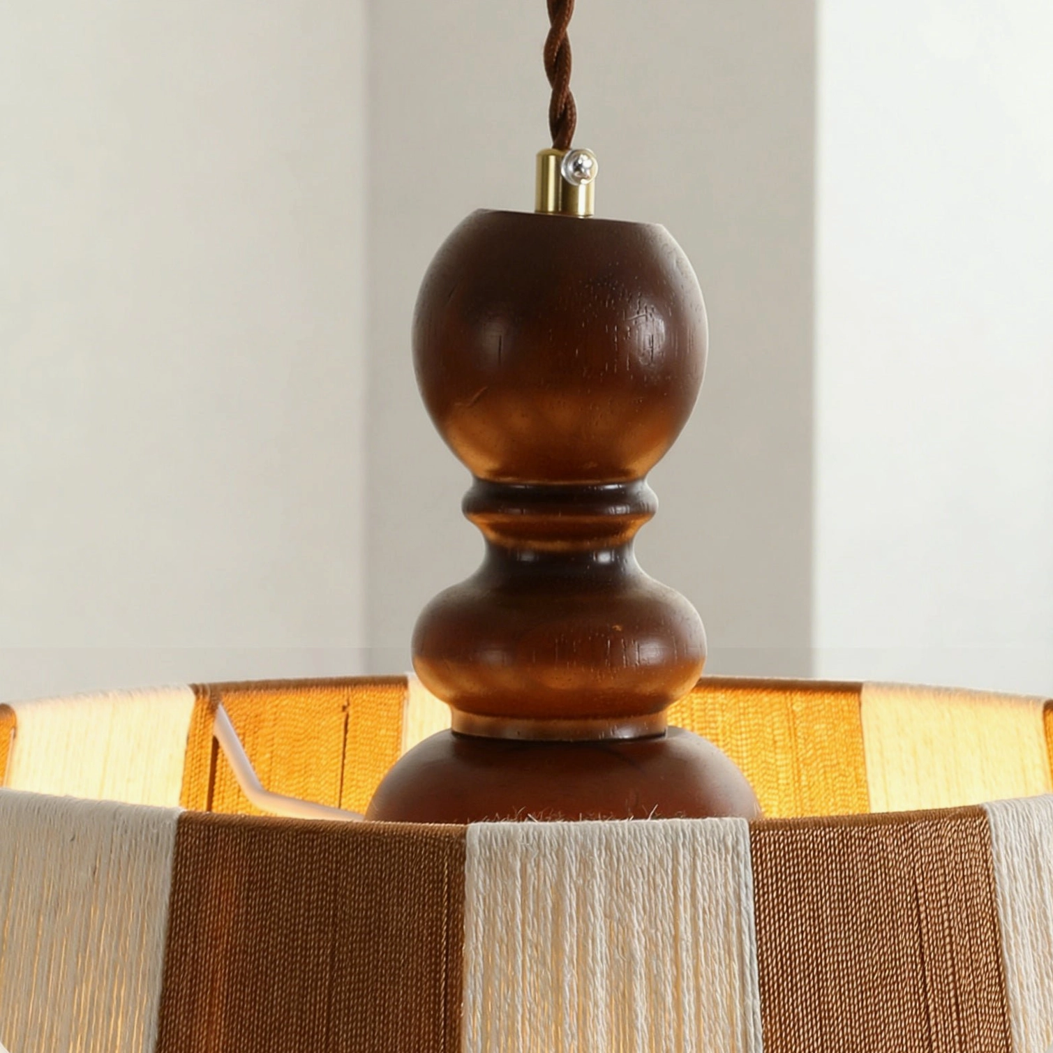 Beatrice pendant lamp close-up detail showing carved wooden ceiling cap and woven fabric shade interior texture